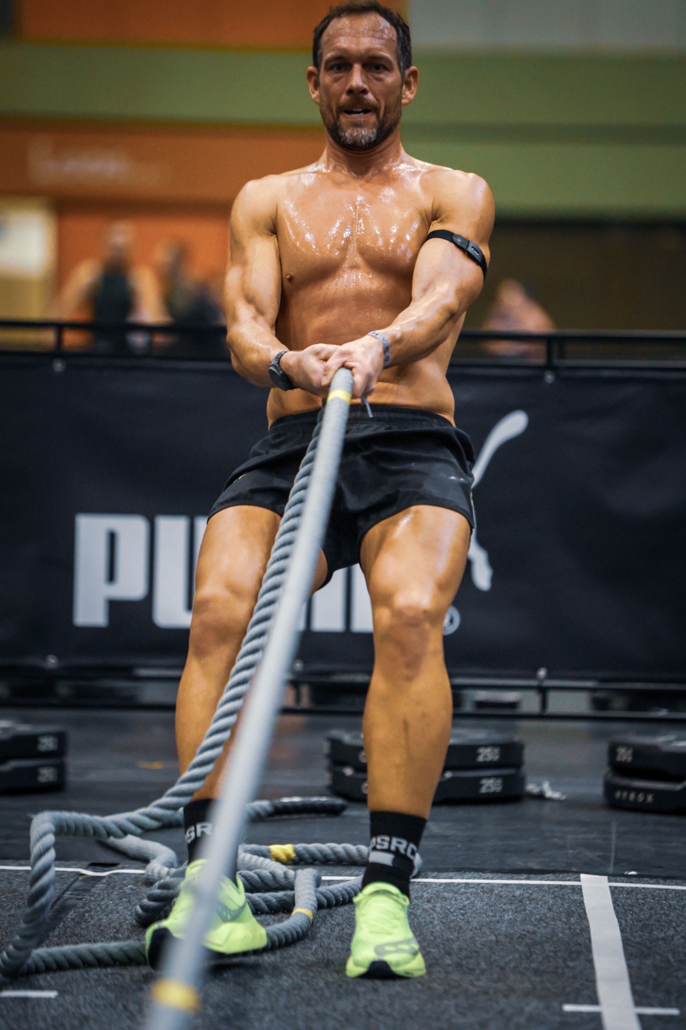 Alex Foster working on the rope pull during a HYROX race.